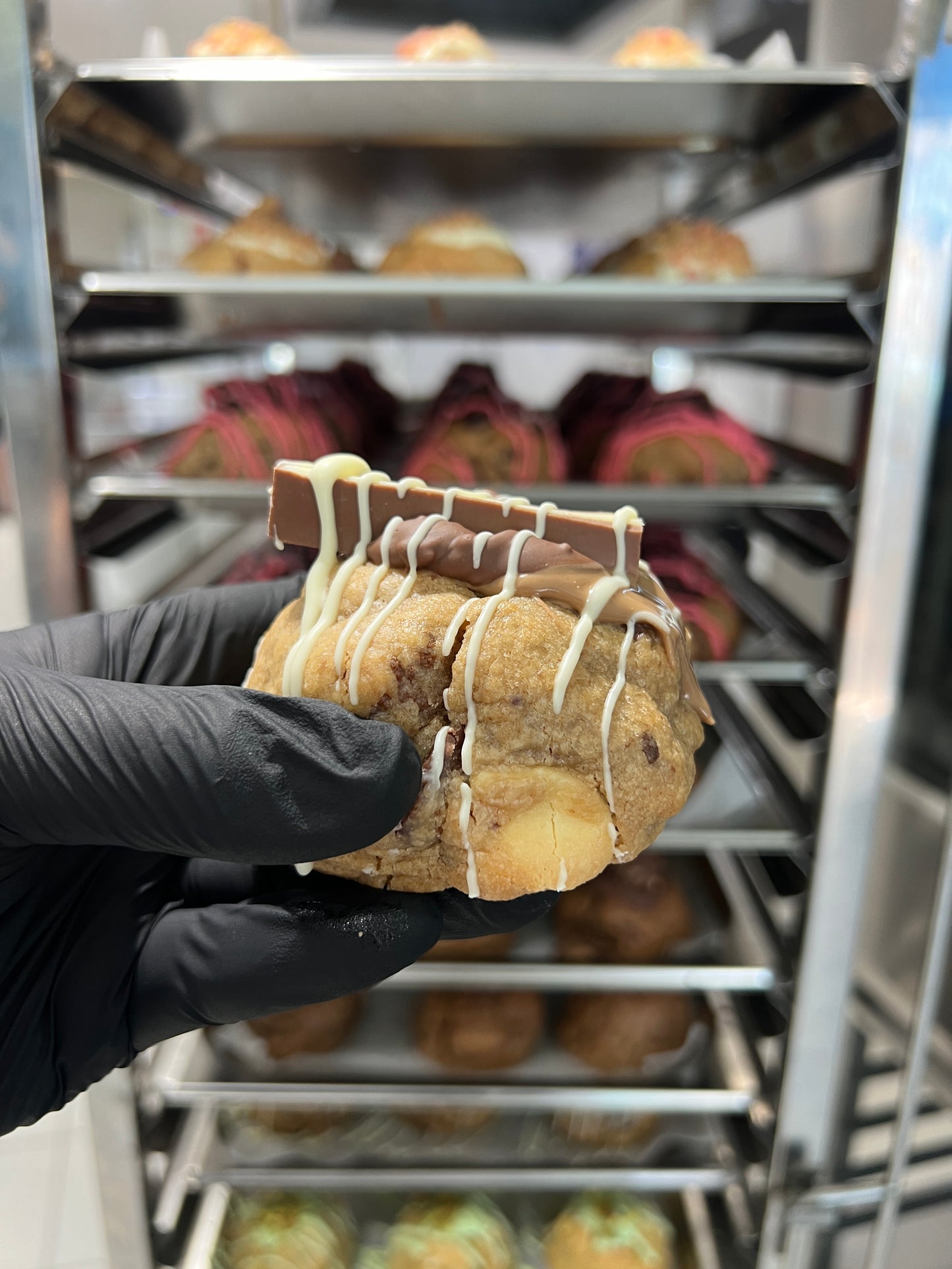 Side view of our Kinder Bueno Loaded Cookie, showcasing its perfect golden-brown exterior and the decadent Kinder Bueno chocolate topping.